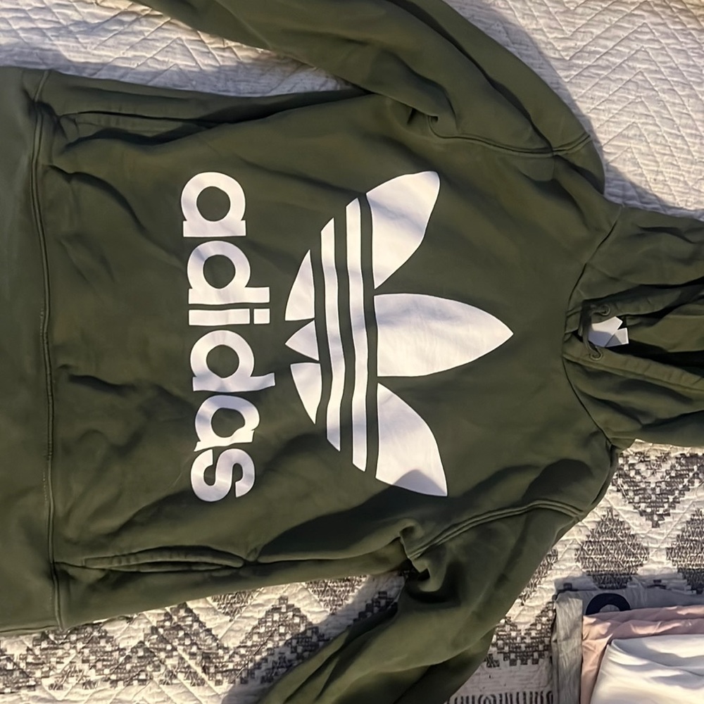 Army green adidas hoodie.